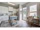 Well-lit kitchen featuring white cabinets, stainless steel appliances, a blue island, and a cozy adjacent office nook at 123 Hyacinth St, Summerville, SC 29483