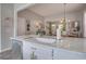 Kitchen island with stainless steel appliances and sink, open to the living and dining areas at 123 Hyacinth St, Summerville, SC 29483