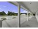 A covered outdoor deck overlooks the pool and green space, perfect for outdoor living and relaxation at 123 Hyacinth St, Summerville, SC 29483