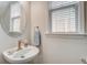 Clean and modern half-bathroom with a stylish vessel sink, round mirror, and natural light at 123 Hyacinth St, Summerville, SC 29483