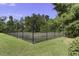 A fenced community tennis court surrounded by lush greenery for recreational enjoyment at 123 Hyacinth St, Summerville, SC 29483