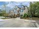Charming multi-Gathering exterior showcasing manicured lawn, individual garages, and neatly paved driveways in serene area at 1271 Dingle Rd, Mount Pleasant, SC 29466