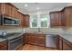Updated kitchen with stainless steel appliances, granite countertops, and stylish dark wood cabinets at 1271 Dingle Rd, Mount Pleasant, SC 29466