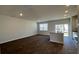Open concept living area with kitchen island, stainless appliances, and access to the patio at 135 Yarrow Way, Moncks Corner, SC 29461