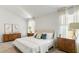 Bright bedroom features neutral walls and decor, a large window, and wood furniture at 137 Yarrow Way, Moncks Corner, SC 29461