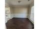 Well-lit dining room with hardwood floors, decorative chair rail, and view into the kitchen space at 1391 Center Lake Dr, Mount Pleasant, SC 29464