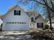 Charming home featuring a classic white exterior, black shutters, attached garage, and inviting curb appeal at 1391 Center Lake Dr, Mount Pleasant, SC 29464