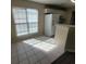 Bright kitchen area with tile floors and a view of a refrigerator and window at 1391 Center Lake Dr, Mount Pleasant, SC 29464