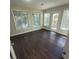Sun-filled room with multiple windows, hardwood floors, and a door leading to the outdoors at 1391 Center Lake Dr, Mount Pleasant, SC 29464