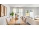 Bright and inviting dining room offering serene backyard views and open concept access to living room at 141 Yarrow Way, Moncks Corner, SC 29461
