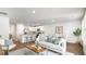 Open-concept kitchen, dining, and living area with bar seating and stainless steel appliances at 141 Yarrow Way, Moncks Corner, SC 29461