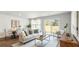Cozy living room and dining area with large windows and hardwood floors at 141 Yarrow Way, Moncks Corner, SC 29461