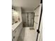 Bright bathroom featuring double sink vanity, glass-enclosed shower with white tile, and modern fixtures at 1414 N Sherwood Dr, Charleston, SC 29407