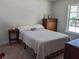 Bright bedroom featuring a comfortable bed, vintage furniture, and warm, neutral tones at 1414 N Sherwood Dr, Charleston, SC 29407
