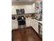 Modern kitchen featuring stainless steel appliances, white cabinets and beautiful hardwood floors at 1414 N Sherwood Dr, Charleston, SC 29407