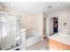 Well-lit bathroom featuring a stand up shower, separate bathtub, and a tile floor at 155 Winding River Dr, Johns Island, SC 29455