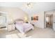 Light-filled bedroom features a bed with nightstand, neutral colors, and ensuite bathroom access at 155 Winding River Dr, Johns Island, SC 29455