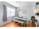 Stylish dining room with a large window, elegant table setting, and hardwood flooring at 155 Winding River Dr, Johns Island, SC 29455