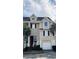 Inviting townhome exterior with a one car garage, complemented by lush landscaping and palm trees at 155 Winding River Dr, Johns Island, SC 29455