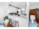 Open-concept kitchen with white cabinets and countertops, breakfast bar, and hardwood floors at 155 Winding River Dr, Johns Island, SC 29455