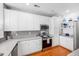 Charming kitchen features white cabinets, stainless steel appliances, and ample counter space at 155 Winding River Dr, Johns Island, SC 29455