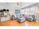 Comfortable living room featuring a plush gray sectional sofa, hardwood floors, and natural light at 155 Winding River Dr, Johns Island, SC 29455