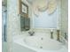 Relaxing bathroom features a soaking tub with jets, complemented by elegant fixtures and soothing wallpaper at 177 Thousand Oaks Cir, Goose Creek, SC 29445