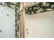 Bathroom with patterned wallpaper, complementing the shower with striped curtain at 177 Thousand Oaks Cir, Goose Creek, SC 29445