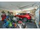 Spacious garage with organized storage, tools, and parked red SUV offering secure parking at 177 Thousand Oaks Cir, Goose Creek, SC 29445