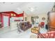 Open concept living room showcasing a spacious layout, a cozy leather sofa, and adjacent kitchen area at 177 Thousand Oaks Cir, Goose Creek, SC 29445