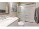 Bathroom with a shower and bathtub combination behind sliding glass doors, a white sink and toilet at 2 Pelican Reach # Share 11, Isle of Palms, SC 29451