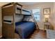 Bedroom with wood bunk beds, a wood ladder, a small desk with a lamp, and a blue-themed bedspread at 2 Pelican Reach # Share 11, Isle of Palms, SC 29451