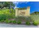 The Wild Dunes community sign is surrounded by lush greenery under a partly cloudy sky at 2 Pelican Reach # Share 11, Isle of Palms, SC 29451