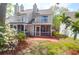 Charming back exterior featuring a screened porch, private balcony, and a serene outdoor patio at 2 Townpark Ln # D, Charleston, SC 29412