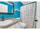 Bright bathroom with modern sink, colorful walls and tile countertop plus map themed shower curtain at 2 Townpark Ln # D, Charleston, SC 29412