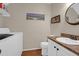 A well-lit bathroom features a vanity with a sink, a toilet, a washer, and a dryer, all in a compact space at 2 Townpark Ln # D, Charleston, SC 29412