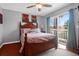 Cozy bedroom with wood-framed bed, ceiling fan, and sliding glass doors to a private balcony at 2 Townpark Ln # D, Charleston, SC 29412