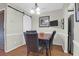 Dining room with hardwood floors and features a sliding barn door, adding a modern touch to the space at 2 Townpark Ln # D, Charleston, SC 29412