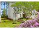 Charming two-story home with an inviting front porch and beautifully landscaped front yard with pink and white flowers at 2 Townpark Ln # D, Charleston, SC 29412