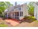 Rear exterior view featuring a multi-story home with brick patios, outdoor spaces, and lawn at 2 Townpark Ln # D, Charleston, SC 29412
