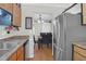 Kitchen view leading to dining room, stainless steel refrigerator, and wood cabinets at 2 Townpark Ln # D, Charleston, SC 29412