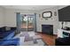 The well-lit living room features a blue sofa, a fireplace, and a sliding glass door to a screened-in porch at 2 Townpark Ln # D, Charleston, SC 29412