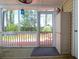 Interior view of screened-in porch, showcasing its screened walls, brick-style flooring, and outdoor view at 2 Townpark Ln # D, Charleston, SC 29412