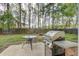Backyard patio with a grill, firepit, and table at 2019 Azalee Ln, Summerville, SC 29483