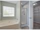 Bright bathroom featuring a garden tub, walk-in shower, and walk-in closet at 2019 Azalee Ln, Summerville, SC 29483