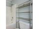 Bathroom featuring a bathtub with a shower and a metal shelf at 2019 Azalee Ln, Summerville, SC 29483