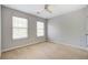 Spacious bedroom with two windows, carpet flooring, and a ceiling fan at 2019 Azalee Ln, Summerville, SC 29483
