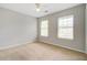 Light-filled bedroom with two windows, carpet flooring, and a ceiling fan at 2019 Azalee Ln, Summerville, SC 29483