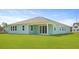 The home's backyard has a covered patio and pristine lawn at 202 Bilge Rd, Ridgeville, SC 29472