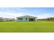 Well-manicured backyard with lawn and covered patio area at 202 Bilge Rd, Ridgeville, SC 29472
